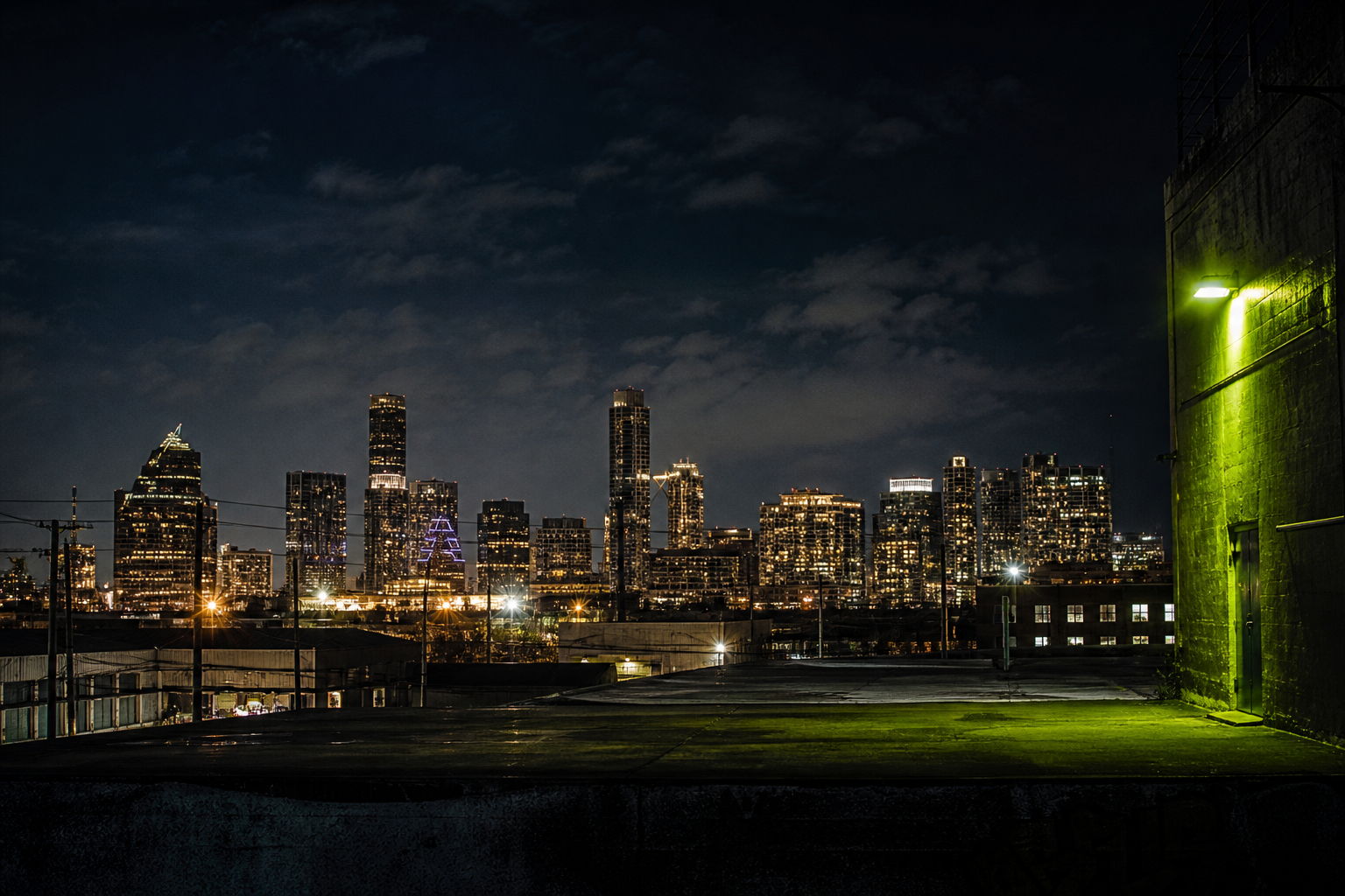 The Austin skyline at night, seen from an industrial rooftop